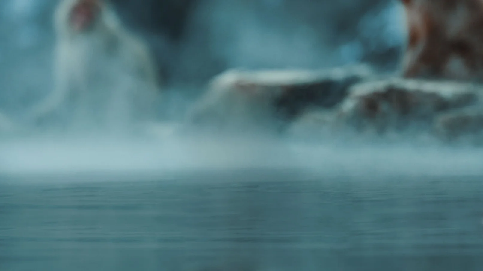 A blurry image of smoke coming from the ocean.